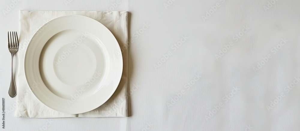 Leinwandbilder a white table with an empty plate on a white tablecloth offers a spot for text. includes copy space 