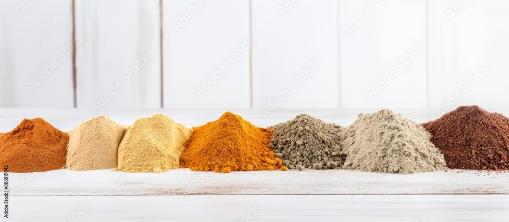 Poster Close-up view of powdered spices on a white wooden surface with ample copy space for text or images.
