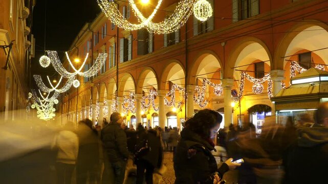 MODENA, ITALY - NOVEMBER 26 2016: People celebrate Christmas and New Year on the street decorated with illuminations. Street Farini, Modena city, Emilia Romagna, Italy.