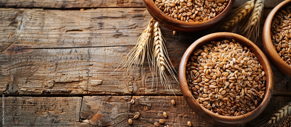 Poster wholegrain spelt farro bowls on a rustic wooden table with copy space image available.