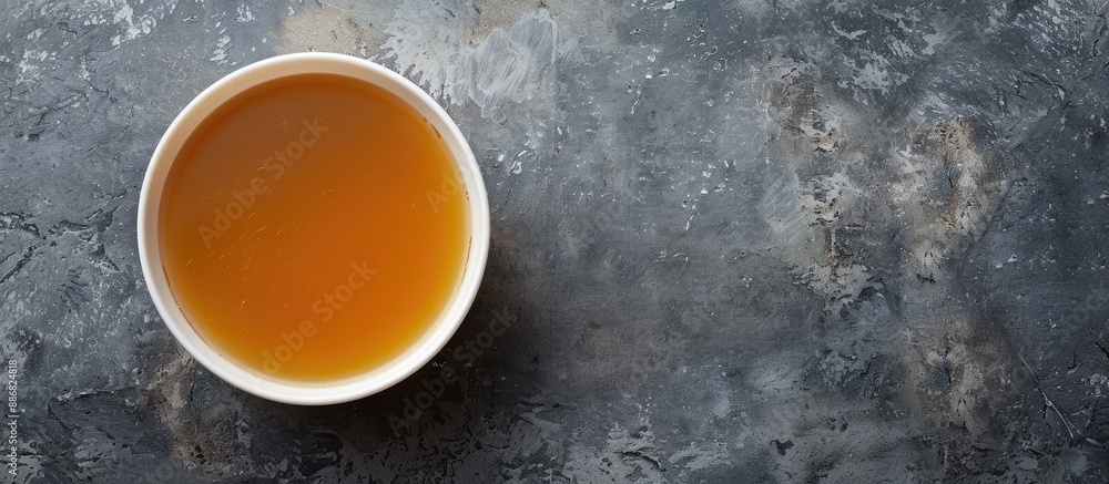 Poster A nourishing bowl of broth on a gray background seen from above, creating an ideal layout for adding a picture or text, suitable for a banner design.