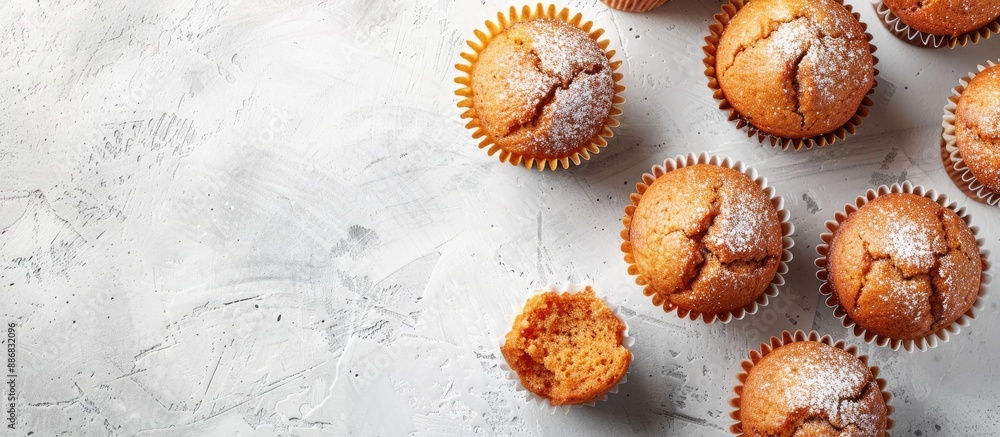 Poster Top view of delectable sweet muffins on a light grey textured surface with a blank area for text, ideal for a copy space image.