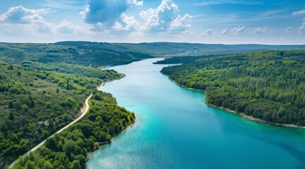 Aerial View of Lake and Forest Landscape with Winding Road