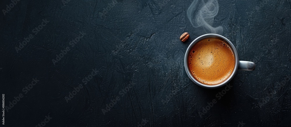 Poster Flat lay of a steaming cup of aromatic hot coffee on a dark background with copy space image.