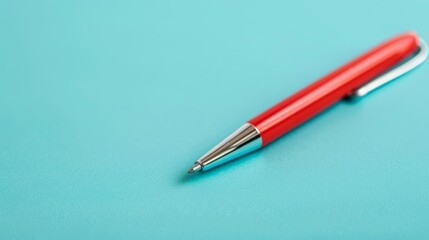  A red ballpoint pen atop a blue surface; tip touching tip