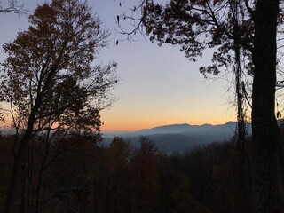 Fototapeta premium sunrise over a mountain range in fall