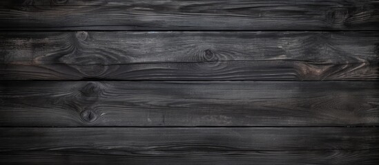 Rustic dark wooden texture with an old black and grey color palette creating a captivating wood background, perfect for a copy space image.