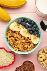 Healthy breakfast set on pink background. Granola with fresh summer berries. Vertical photo