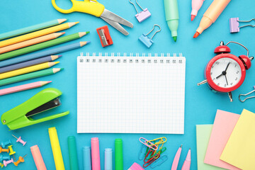 Studio shot of school supplies on blue background. Space for text