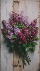 Fototapeta premium Bouquet of lilacs on wooden background