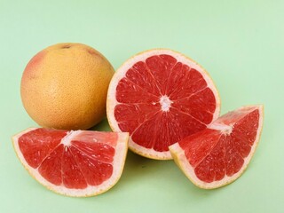 Fresh grapefruit fruit. Grapefruit isolated on green background. Grapefruit with clipping path.