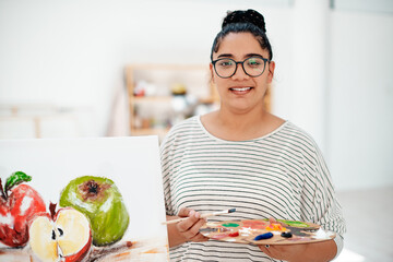 Portrait, woman and artist in studio with painting, paintbrush and color palette for art class or...