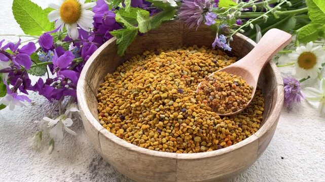 Healthy bee pollen grains.  Bee pollen on a bowl and wild  flowers
