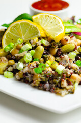 A colorful salad with chickpeas, quinoa, and vegetables