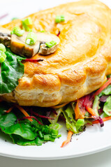 A plate of food with a meat dumpling and a lemon wedge on top