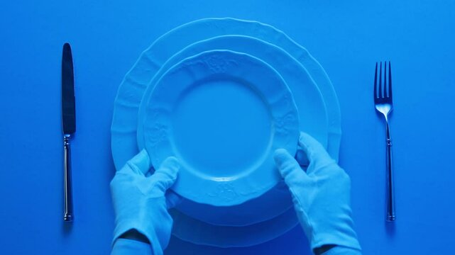 Elegant table setting with white tableware plates, cutlery, and glassware for a classy dining, fancy expensive restaurant dinner
