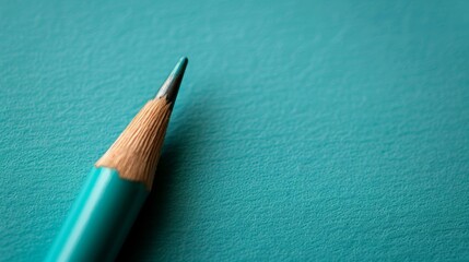  A tight shot of a pencil, its blue writing surface dominating the frame, the tip protruding slightly from the top