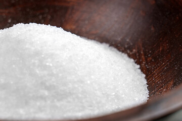 Coarse salt epsom for a relaxing bath and spa with magnesium in a wooden bowl close up. Wellness...