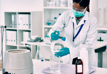 Fototapeta premium Scientist, woman and chemistry with beaker in lab with mask for experiment, research or vaccine analysis. Liquid, healthcare and medicine person for molecule structure, developing cure or innovation