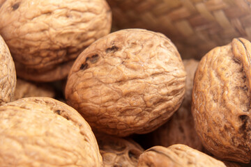 Whole organic walnuts with detailed textured shell close up view. Sustainable food ingredients. Macro shot. 