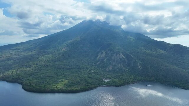 Clouds gather around the peak of the scenic volcano of Lewotolok on island of Lembata, Indonesia. This beautiful and biodiverse area is part of the famed Ring of Fire and is volcanically active.