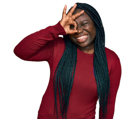 Young black woman with braids wearing casual clothes smiling happy doing ok sign with hand on eye looking through fingers