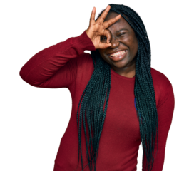 Young black woman with braids wearing casual clothes smiling happy doing ok sign with hand on eye looking through fingers