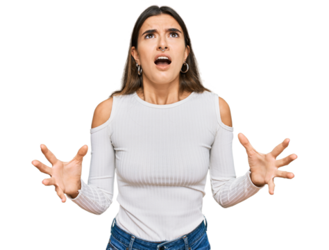 Young hispanic woman wearing casual clothes crazy and mad shouting and yelling with aggressive expression and arms raised. frustration concept.