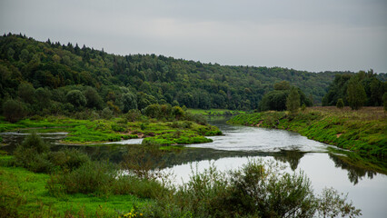 Tranquil riverside with lush greenery and scenic water creates a serene atmosphere for relaxation
