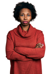 African american woman with afro hair with arms crossed gesture relaxed with serious expression on...