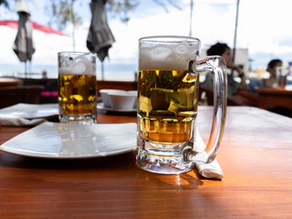 Jars of beer in an outdoor restaurant.