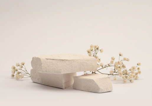 White Stones platform podium, dry flower twig on beige light background. Minimal empty display product presentation scene.