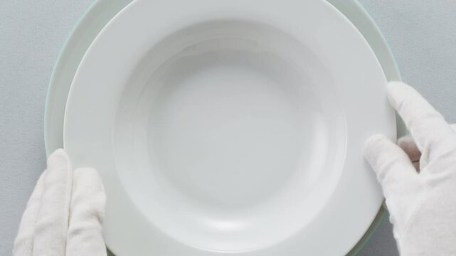 Elegant table setting with white tableware plates, cutlery, and glassware for a classy dining, fancy expensive restaurant dinner