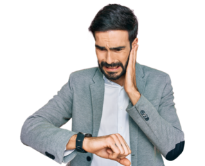 Young hispanic man wearing business clothes looking at the watch time worried, afraid of getting late