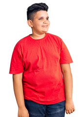 Little boy kid wearing casual clothes looking away to side with smile on face, natural expression. laughing confident.