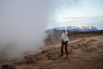 Young woman walks in Myvatn Geothermal Area, Iceland