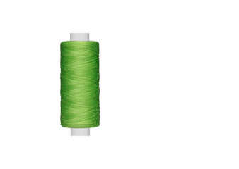 green spool of sewing thread isolated on white background close up