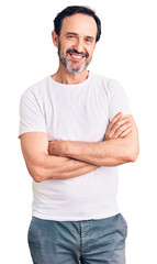 Fototapeta premium Middle age handsome man wearing casual t-shirt happy face smiling with crossed arms looking at the camera. positive person.