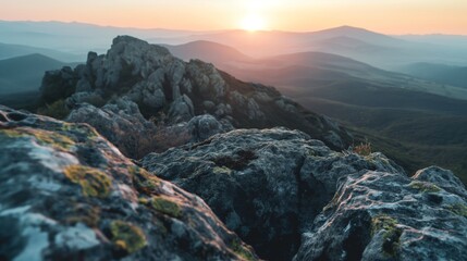 A mountain top with rugged rocks in a beautiful sunrise. Mountain with rocks and moss under soft shadows and vibrant colors.