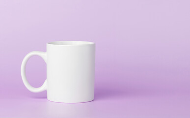 white cup for tea or coffee on a violet, purple background