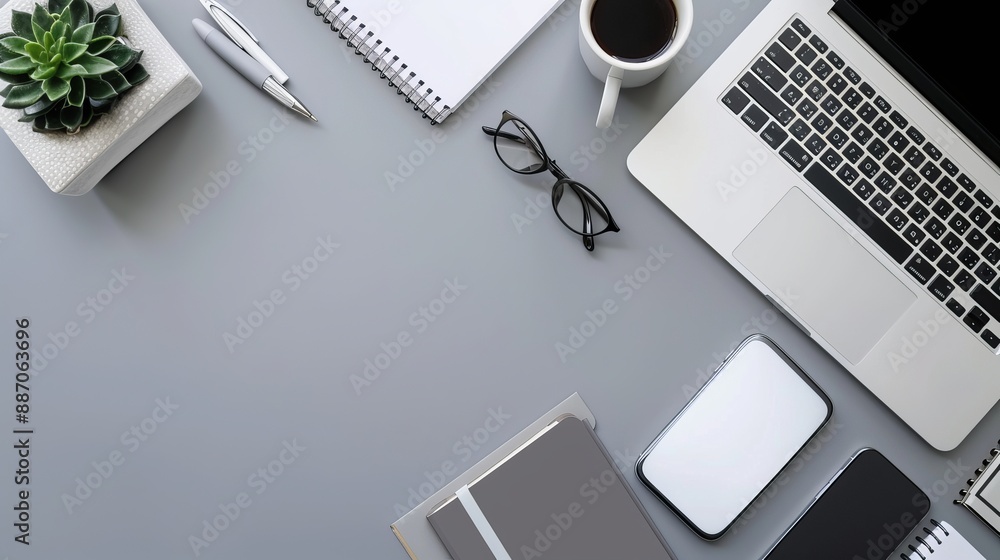 Wall mural top view of office essentials including a notepad laptop coffee cup mouse pad and mobile phone with 