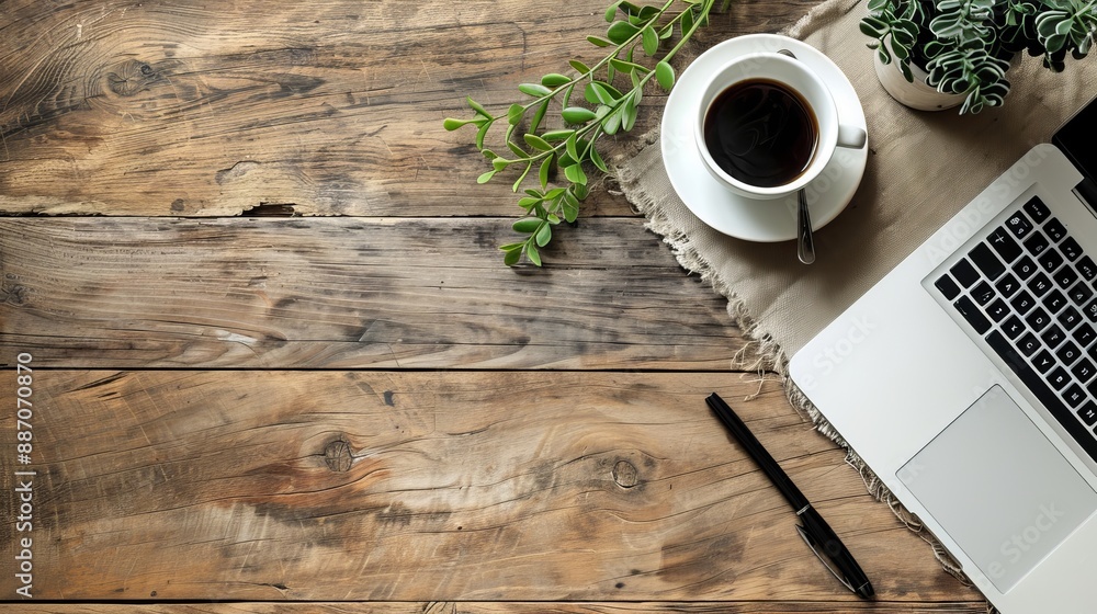 Wall mural work from home concept office desk setup with a laptop blank notepad coffee cup and pen on a wooden 