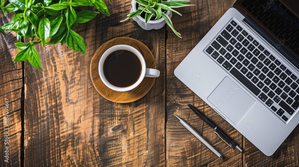 Wall mural work from home concept office desk setup with a laptop blank notepad coffee cup and pen on a wooden 