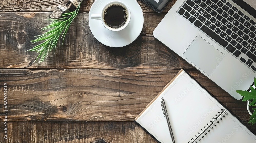 Wall mural work from home concept office desk setup with a laptop blank notepad coffee cup and pen on a wooden 