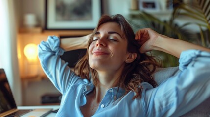 Young, happy Italian woman in a light blue blouse, relaxing with hands behind her head at her cozy home office
