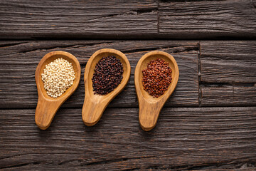Chenopodium quinoa - White, red and black quinoa seeds in three spoons