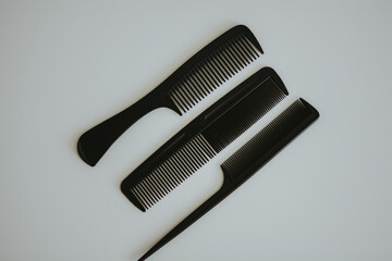 three types of black women's hair combs on a background white background