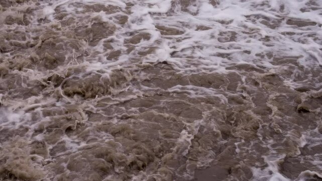 Bubbling Mud Flow. Powerful streams of dirty water after heavy rain. Slow Motion
