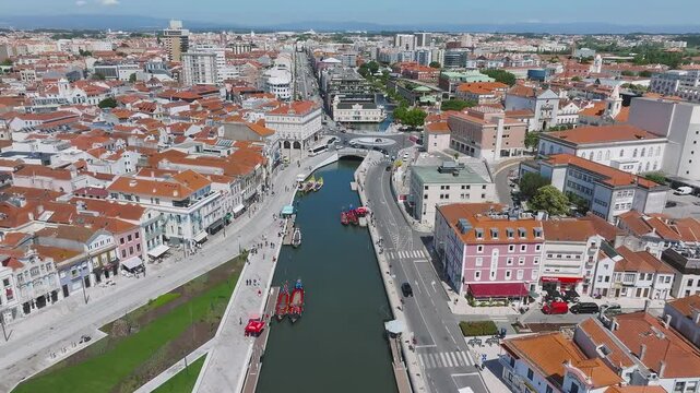 Beautiful aerial view of Aveiro city in Portugal. Aveiro Water canal of Ria de Aveiro with typical boats and tourists, cityscape in the background.