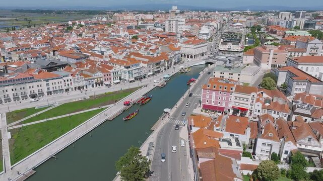 Beautiful aerial view of Aveiro city in Portugal. Aveiro Water canal of Ria de Aveiro with typical boats and tourists, cityscape in the background.